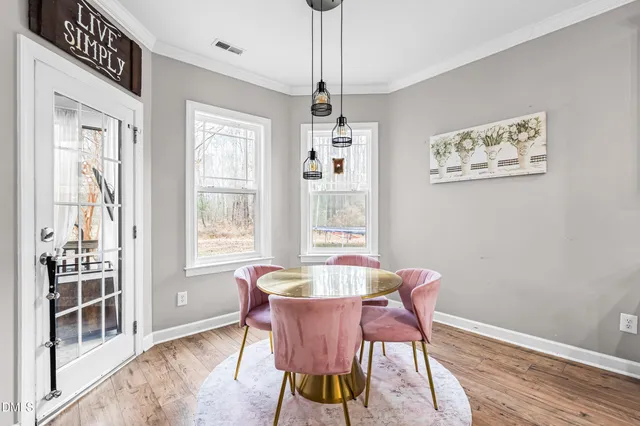 a dining room with furniture and window
