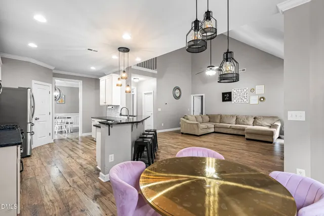 a living room with furniture and kitchen view