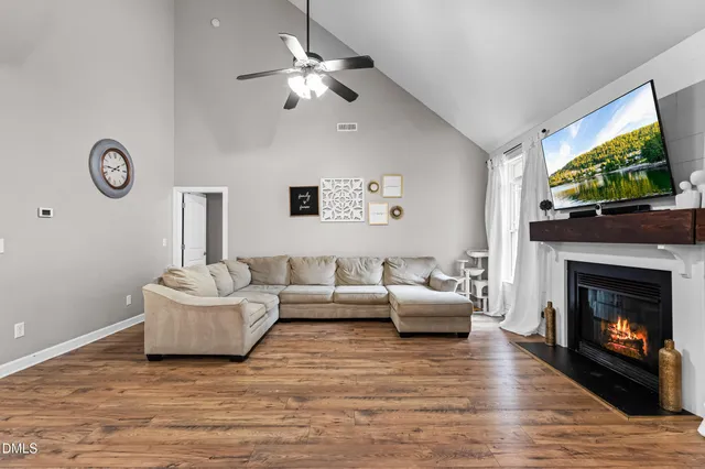 a living room with fireplace furniture and a flat screen tv