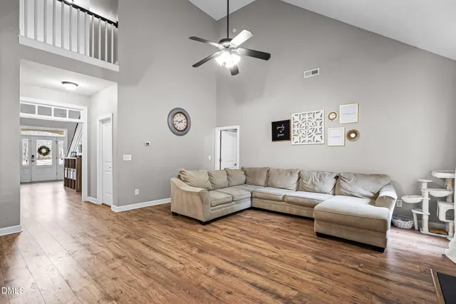 a living room with furniture and a wooden floor