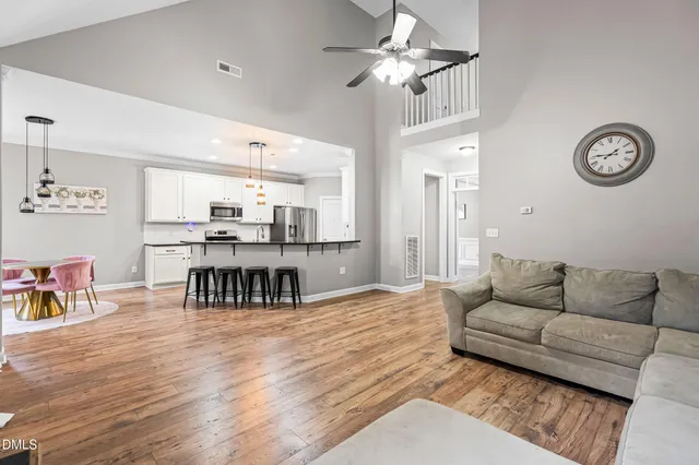 a living room with furniture and a wooden floor
