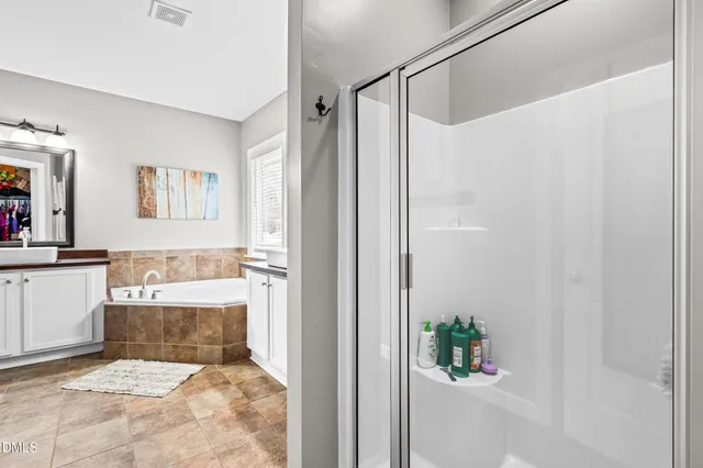 a bathroom with a shower and a bath tub