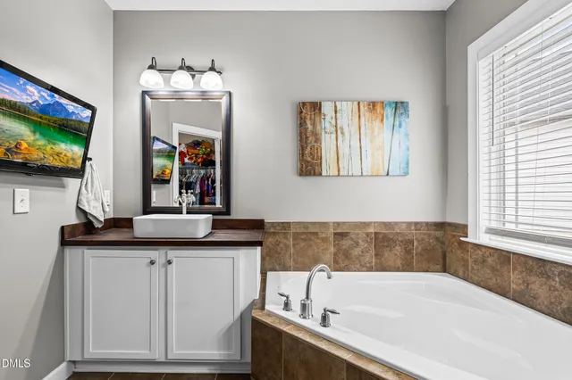 a bath room with a sink and a mirror