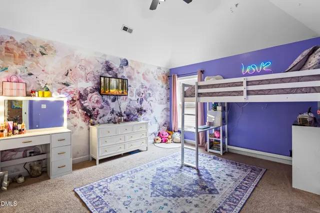 a bedroom with a bed and a book shelf