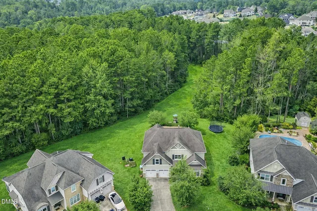 an aerial view of a house with garden space and street view
