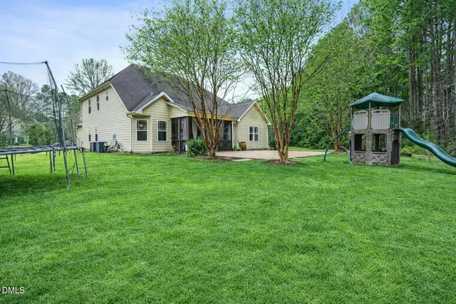 a view of a backyard with large trees
