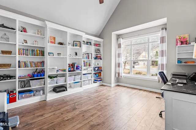 a living room with furniture and a book shelf