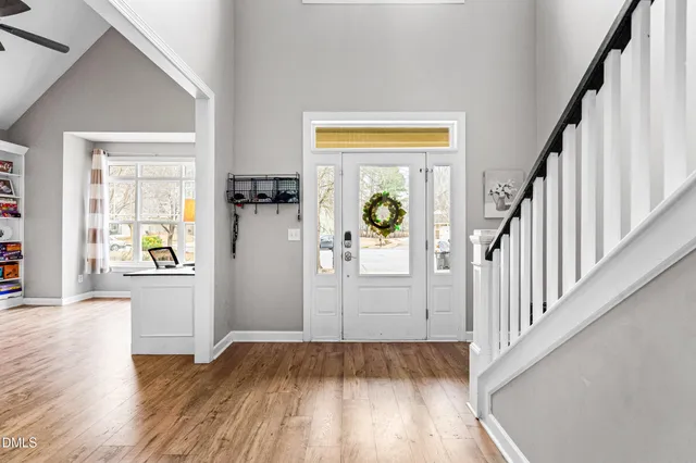 a view of a hallway view with wooden floor and staircase