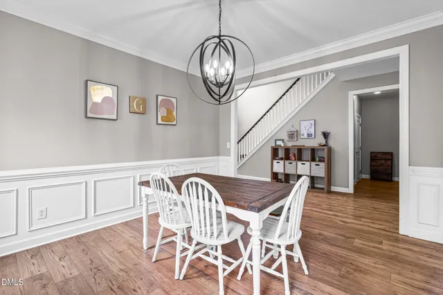 a view of a dining room with furniture wooden floor and a chandelier