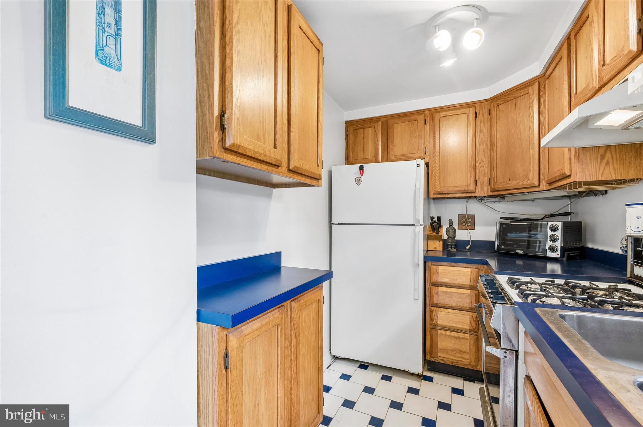 2119 Rodman Street Philadelphia, PA 19146 - Photo 11 of 24 a kitchen with stainless steel appliances granite countertop a refrigerator and a stove