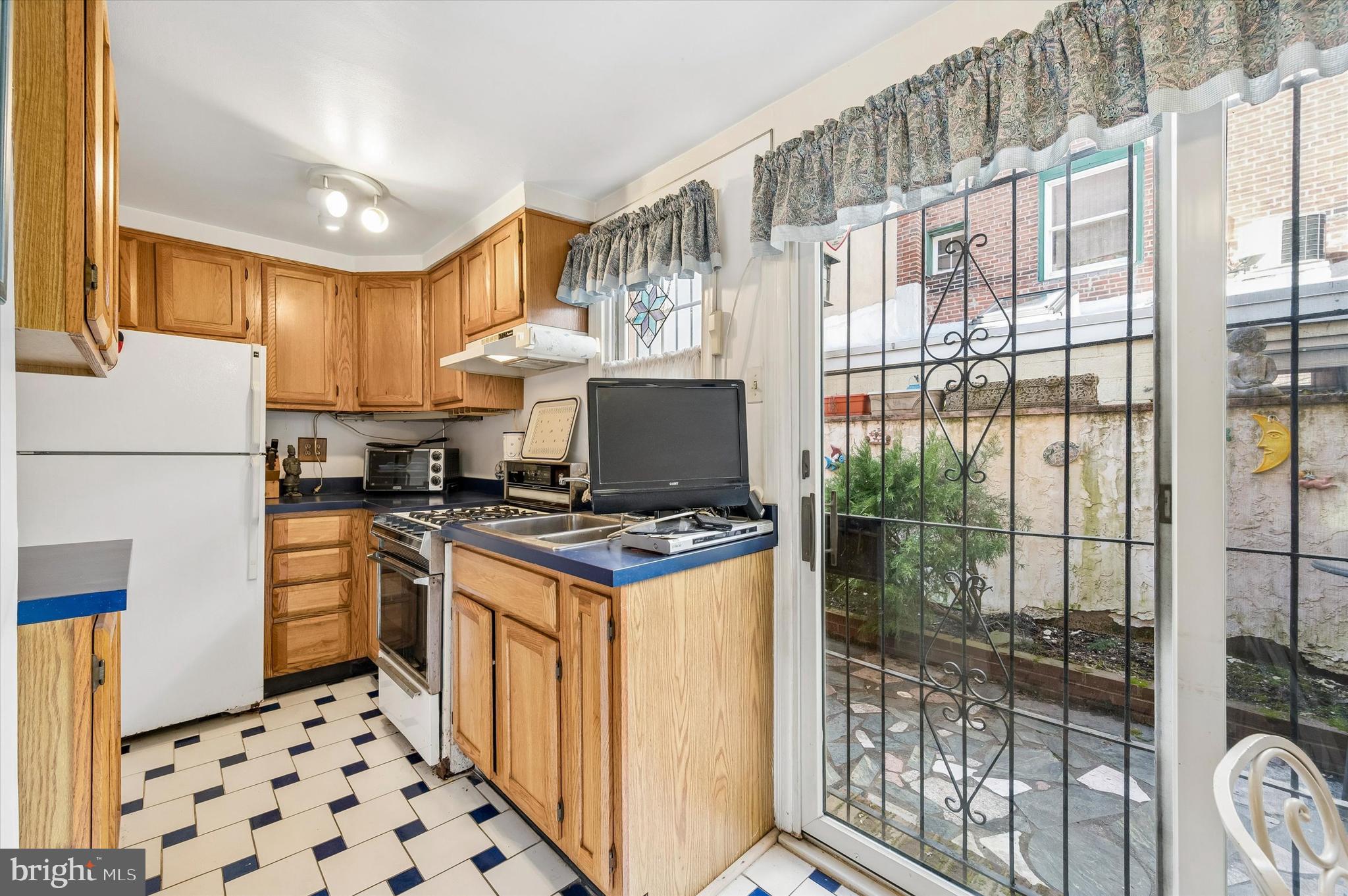 2119 Rodman Street Philadelphia, PA 19146 - Photo 12 of 24 a kitchen with stainless steel appliances granite countertop a stove a refrigerator and a cabinets