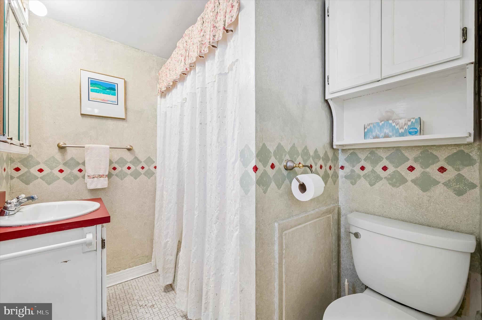 2119 Rodman Street Philadelphia, PA 19146 - Photo 18 of 24 a bathroom with a sink toilet and a shower curtain