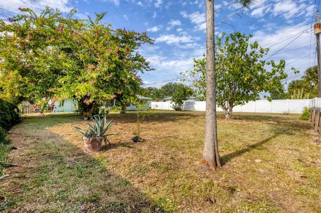 a living room with furniture and a dining table