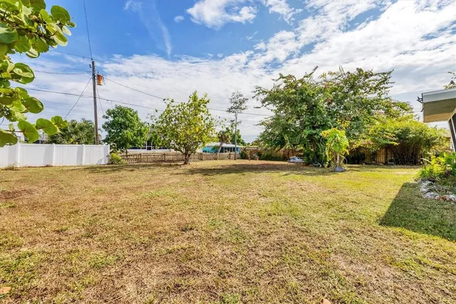 a living room with furniture and view of kitchen