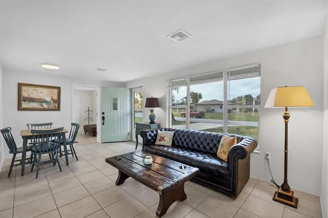 a view of a dining room with furniture and window