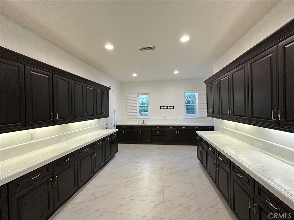 20 Hyacinth Lake Forest, CA 92630 - Photo 13 of 25 a large kitchen with a large counter top and stainless steel appliances