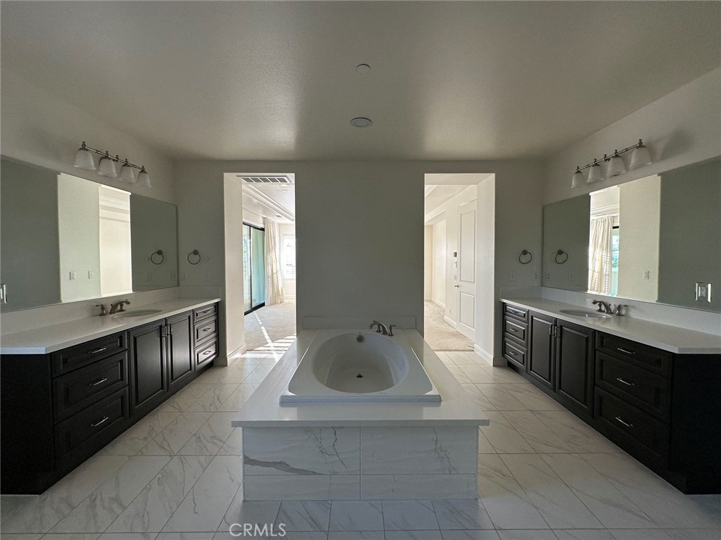 20 Hyacinth Lake Forest, CA 92630 - Photo 19 of 25 a large bathroom with a double vanity sink a large mirror and a bathtub