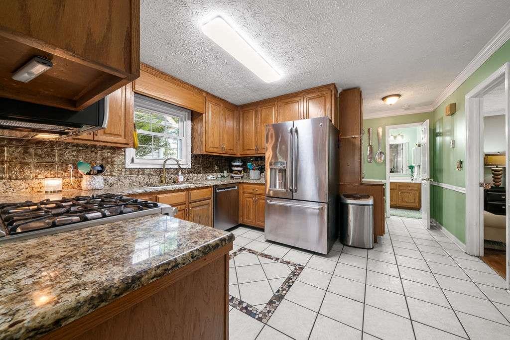 7 College View Drive Southwest Rome, GA 30161 - Photo 15 of 49 a kitchen with granite countertop a refrigerator and a stove top oven