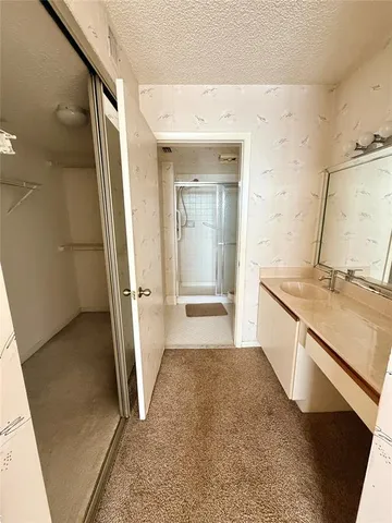 an empty room with a window and a ceiling fan