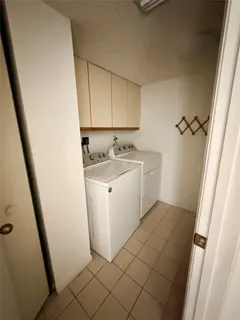 a kitchen with a refrigerator a sink and a stove top oven