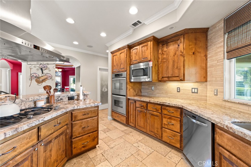 38136 Butterfly Court Yucaipa, CA 92399 - Photo 35 of 71 a large kitchen with stainless steel appliances granite countertop sink stove and cabinets