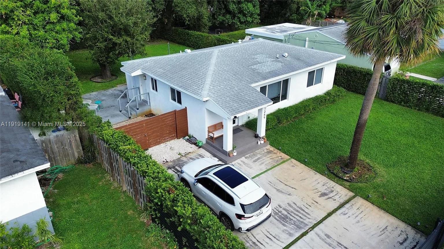 an aerial view of a house with a yard