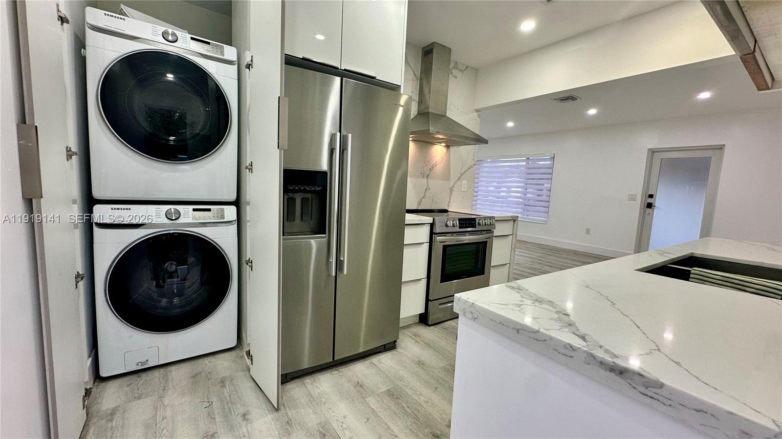 1269 Northeast 145th Street Miami, FL 33161 - Photo 13 of 25 a kitchen with a washer and dryer in it