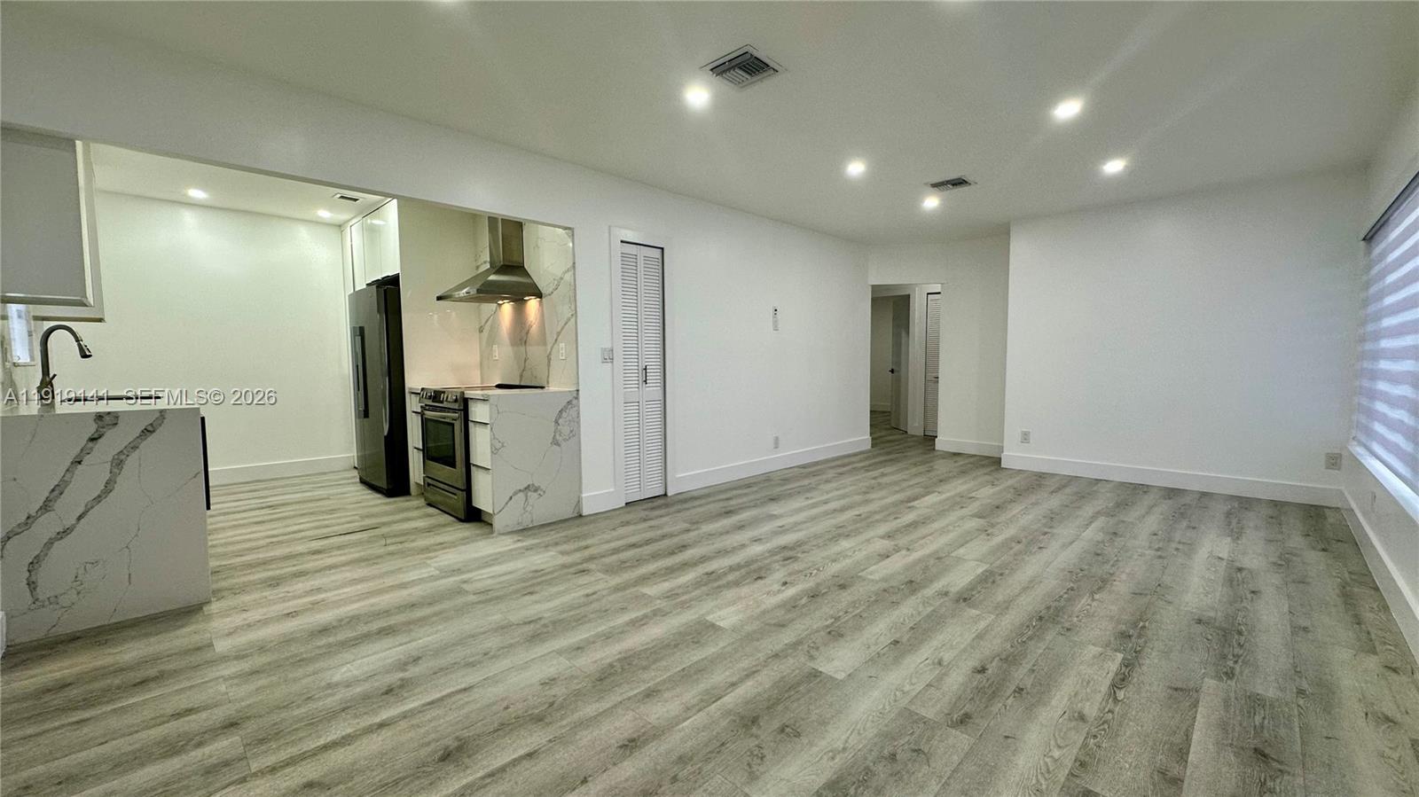 1269 Northeast 145th Street Miami, FL 33161 - Photo 16 of 25 a view of empty room with wooden floor