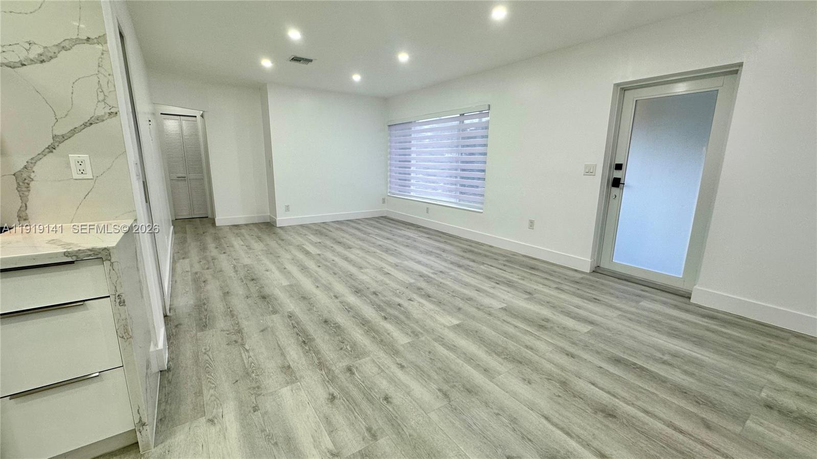1269 Northeast 145th Street Miami, FL 33161 - Photo 17 of 25 a view of empty room with wooden floor