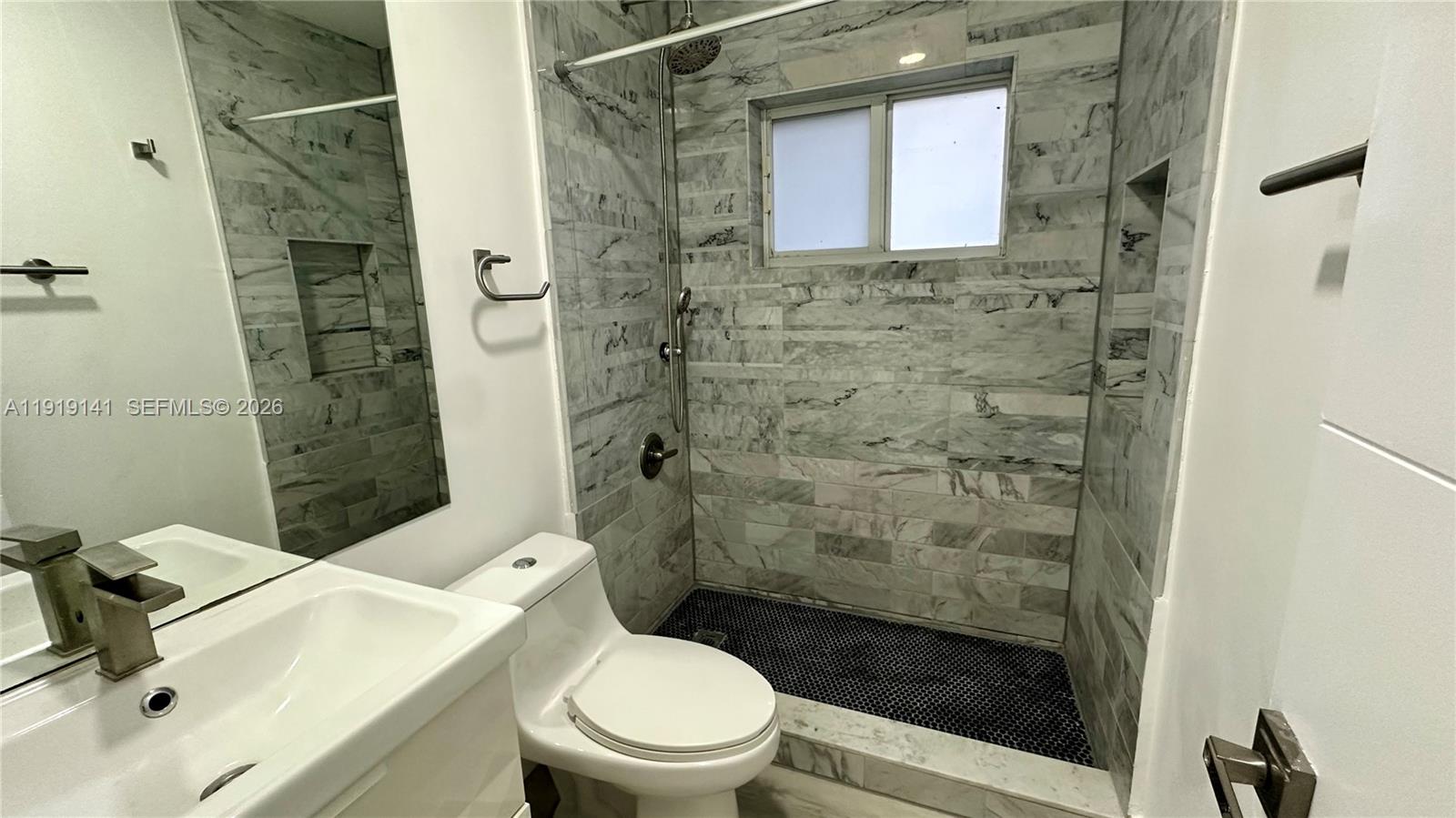 1269 Northeast 145th Street Miami, FL 33161 - Photo 20 of 25 a bathroom with a toilet and a shower