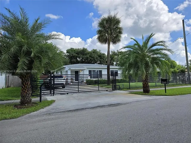 a house with palm trees in front of it
