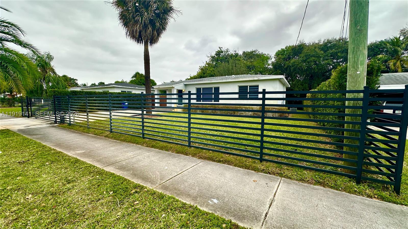 1269 Northeast 145th Street Miami, FL 33161 - Photo 9 of 25 a view of a house with a yard and potted plants