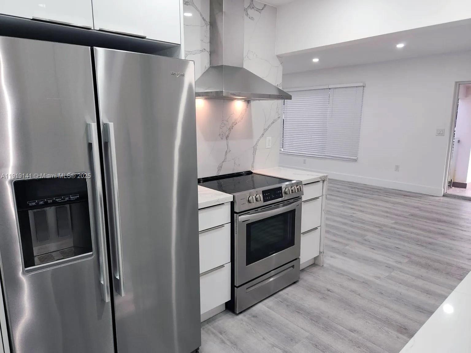 1269 Northeast 145th Street Miami, FL 33161 - Photo 10 of 13 a kitchen with stainless steel appliances granite countertop a refrigerator and a stove