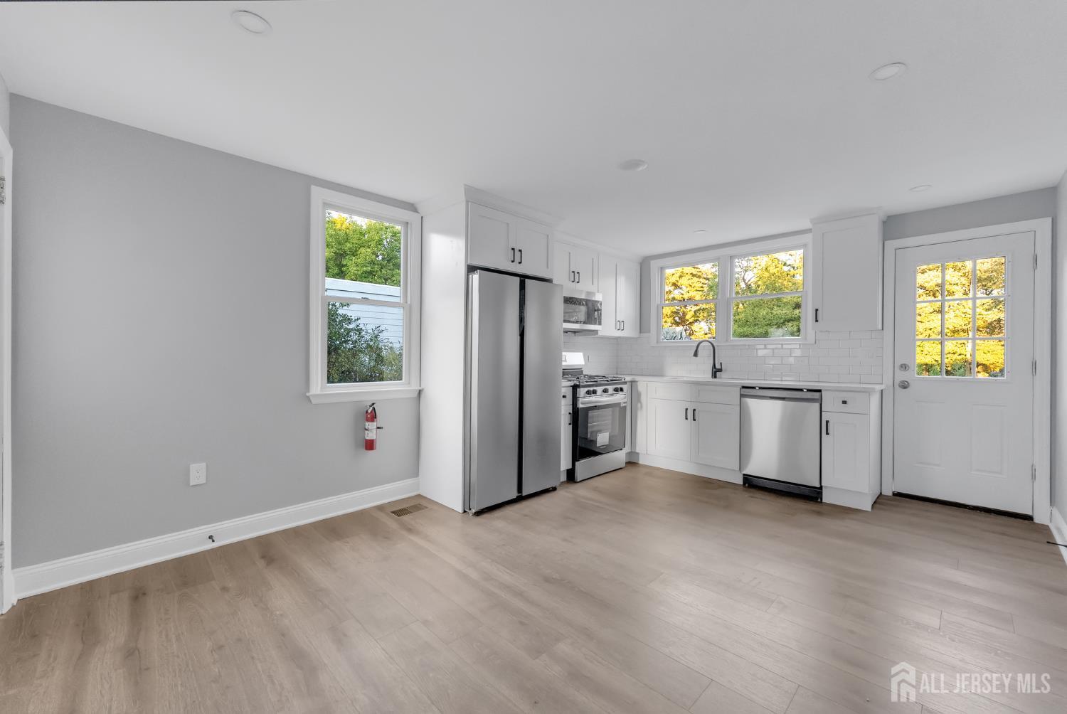 15 North Main Street, Unit A Pennington, NJ 08534 - Photo 3 of 9 a kitchen with stainless steel appliances a refrigerator and a stove top oven