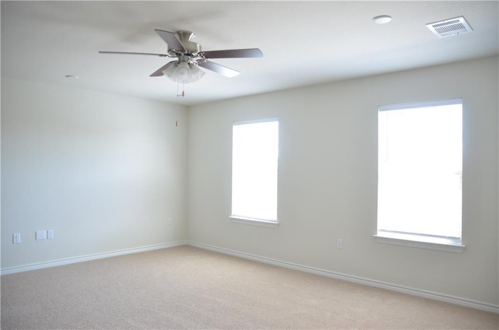 14403 McCoy Loop Austin, TX 78717 - Photo 17 of 29 A quiet space awaits, with soft carpeting and abundant natural light from two tall windows.