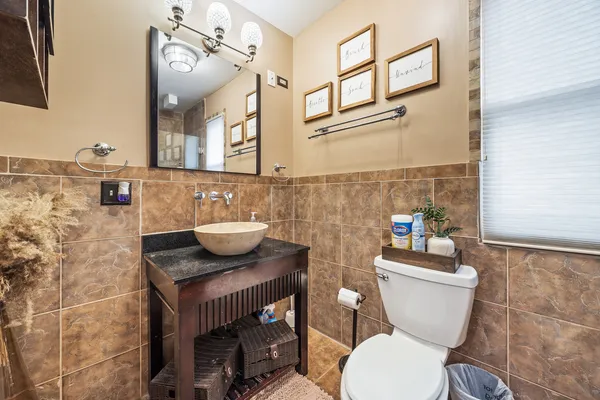 a bathroom with a toilet a sink and a mirror