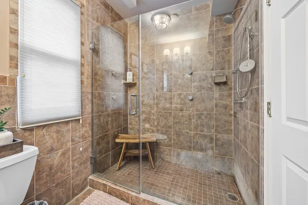 a bathroom with a shower and a toilet