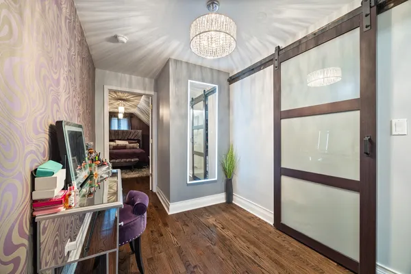 a view of a dining room with furniture a chandelier and wooden floor