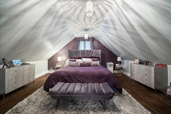 a bed room with a bed and a chandelier