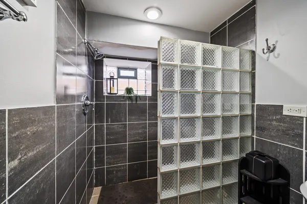 a bathroom with a shower and a sink