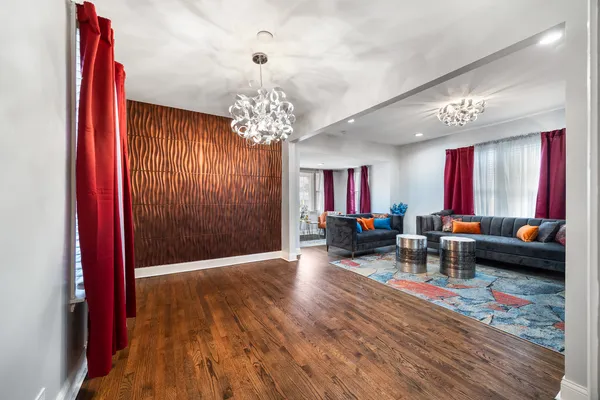 a living room with furniture and a chandelier