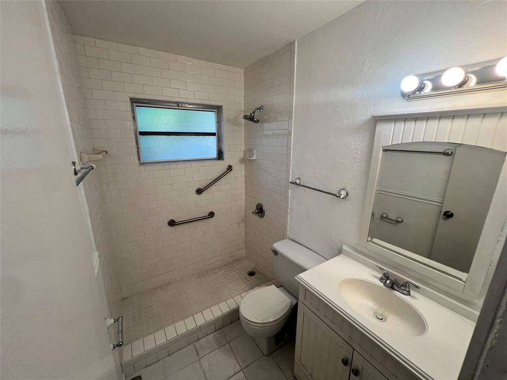 3321 Grove Road Boynton Beach, FL 33435 - Photo 7 of 9 a bathroom with a sink a toilet and shower
