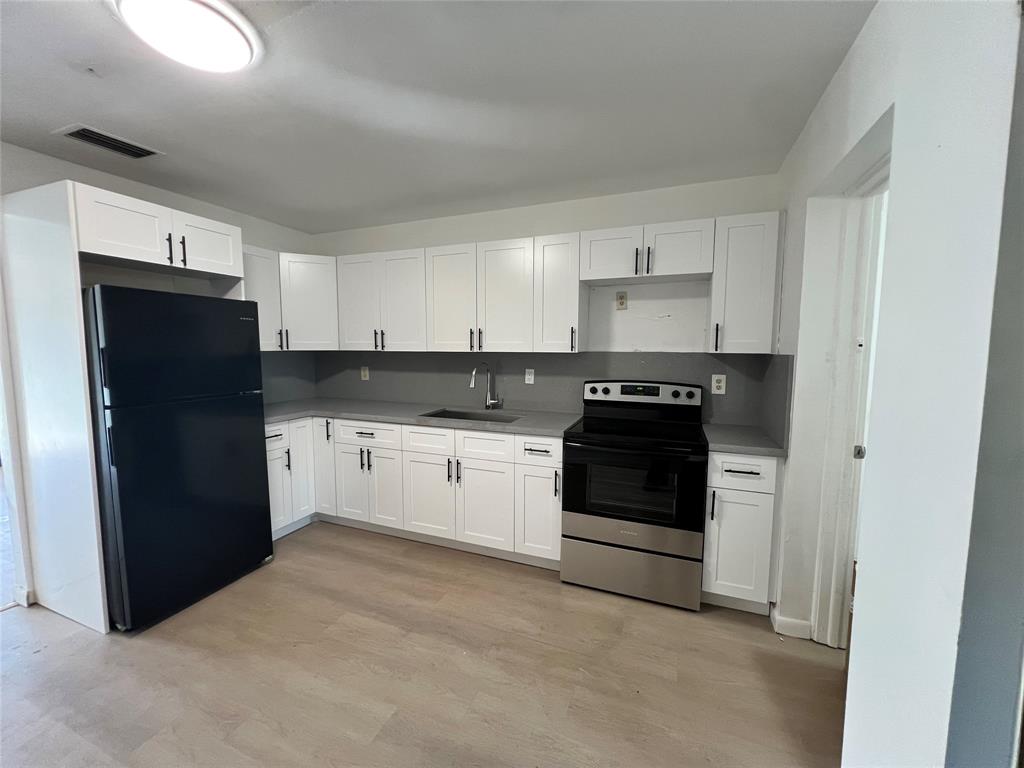 3321 Grove Road Boynton Beach, FL 33435 - Photo 8 of 9 a kitchen with a refrigerator and a stove