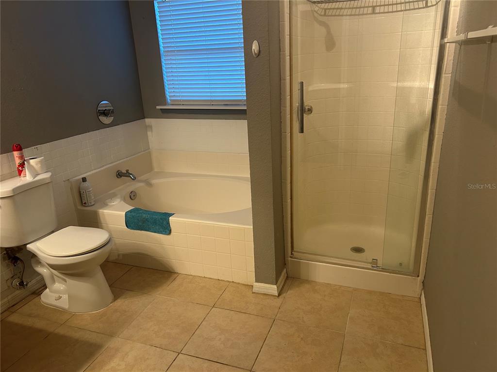 706 Hawk Lane Kissimmee, FL 34759 - Photo 6 of 9 a bathroom with a toilet and a shower