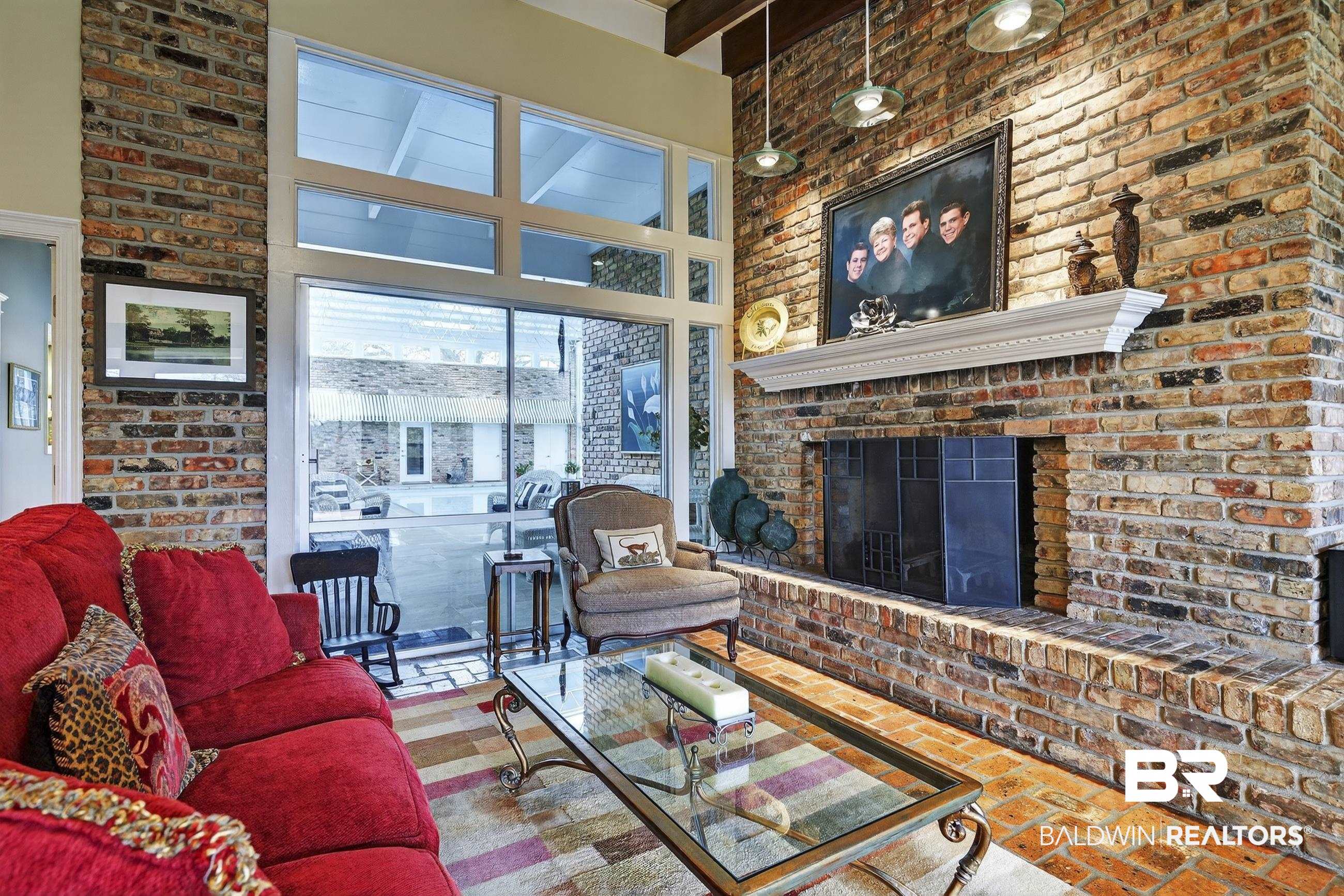 3175 Dawes Lake Road Mobile, AL 36619 - Photo 8 of 92 Living room with brick wall, a brick fireplace, a high ceiling, and brick floors