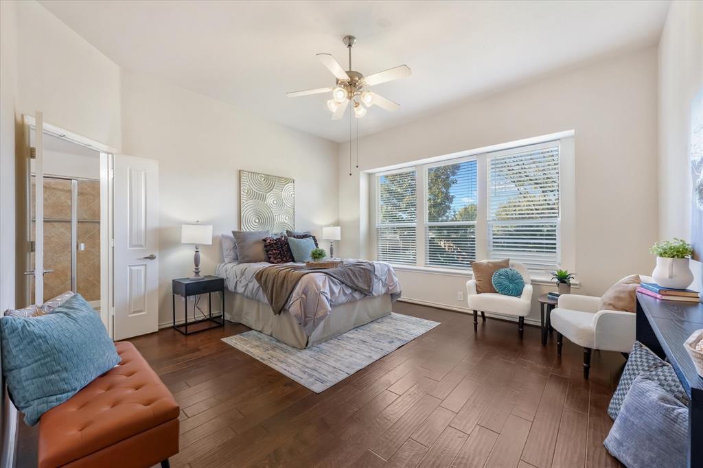 12811 Greenhaven Drive Frisco, TX 75035 - Photo 14 of 28 a spacious bedroom with a bed a couch and a large window