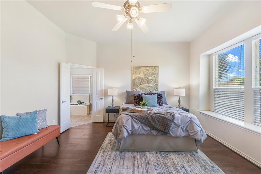 12811 Greenhaven Drive Frisco, TX 75035 - Photo 15 of 28 a bedroom with a bed and wooden floor