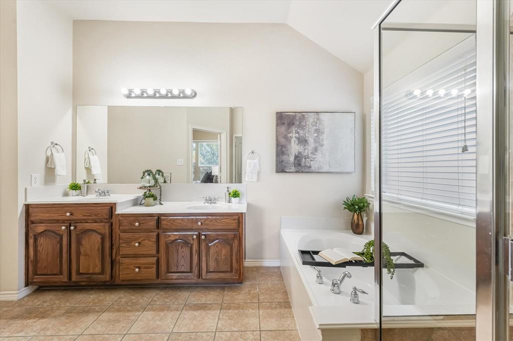 12811 Greenhaven Drive Frisco, TX 75035 - Photo 16 of 28 a spacious bathroom with a granite countertop sink a mirror and a bathtub