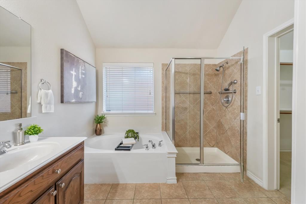 12811 Greenhaven Drive Frisco, TX 75035 - Photo 17 of 28 a bathroom with a tub sink and mirror