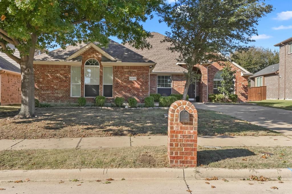 12811 Greenhaven Drive Frisco, TX 75035 - Photo 2 of 28 a front view of a house with a yard